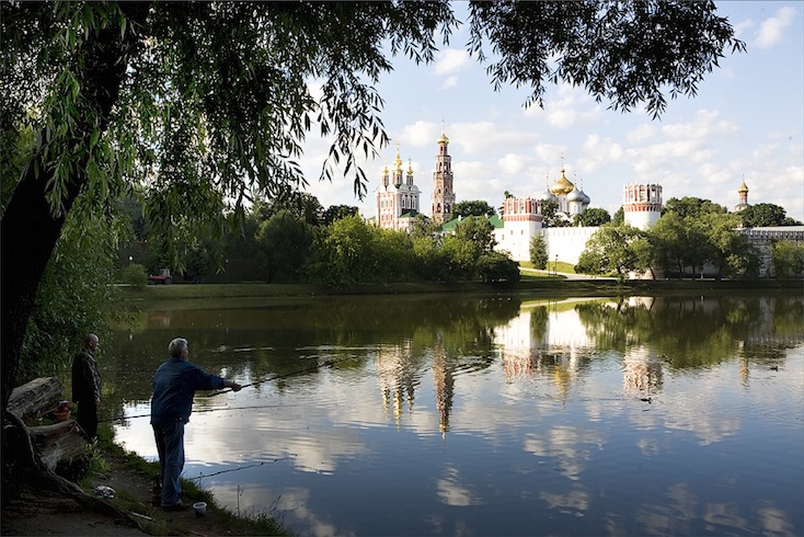Men fishing in the lake by Novodevichy Convent, Moscow - a UNESCO world heritage site Men fishing in the lake by Novodevichy Convent, Moscow - a UNESCO world heritage site